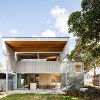 A modern two-storey house whose ground level fully opens onto a backyard area
