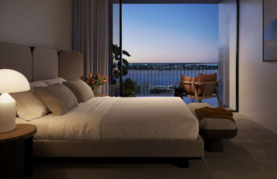 Master bedroom at dusk with balcony door open, overlooking the Port of Newcastle and Stockton