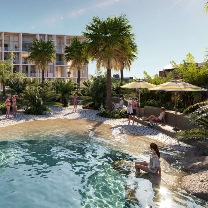 People in swimwear by a resort-style rooftop pool surrounded by tropical landscaping