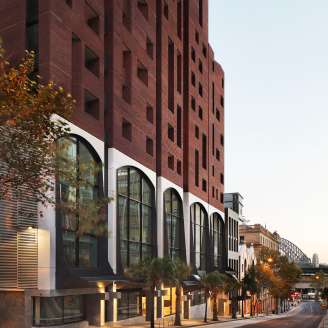 Restored heritage façade of a commercial building with Sydney Harbour Bridge in background